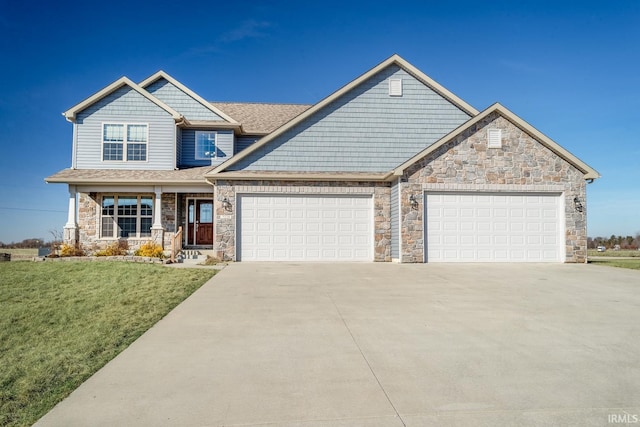 craftsman-style home with a porch, a garage, and a front yard