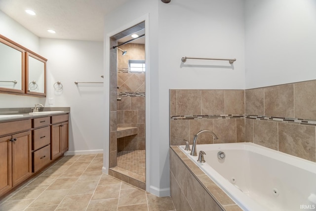 bathroom with tile patterned flooring, vanity, and shower with separate bathtub