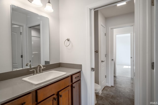 bathroom with vanity and toilet