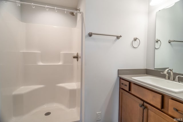 bathroom featuring vanity and a shower