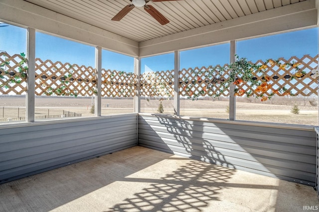 unfurnished sunroom with ceiling fan