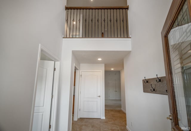 hallway featuring a towering ceiling