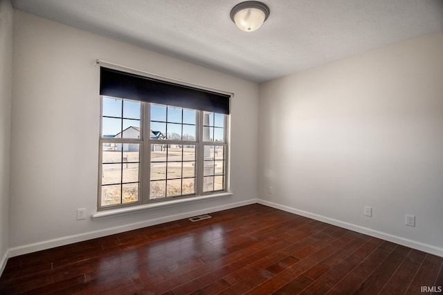 spare room with dark wood-type flooring