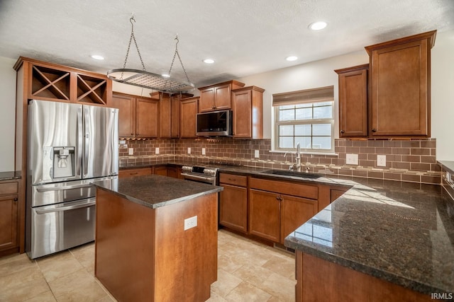 kitchen featuring a kitchen island, tasteful backsplash, appliances with stainless steel finishes, and sink