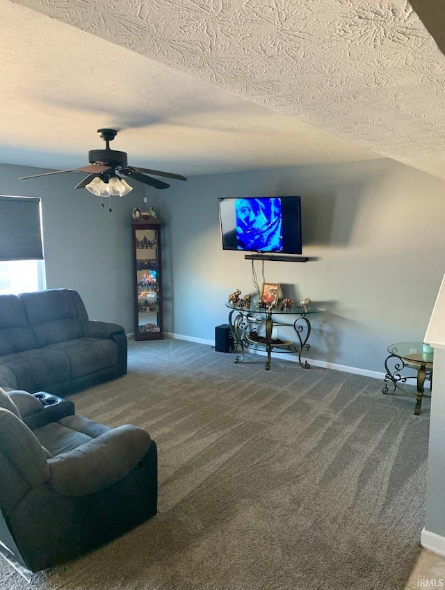 living room with ceiling fan, carpet, and a textured ceiling