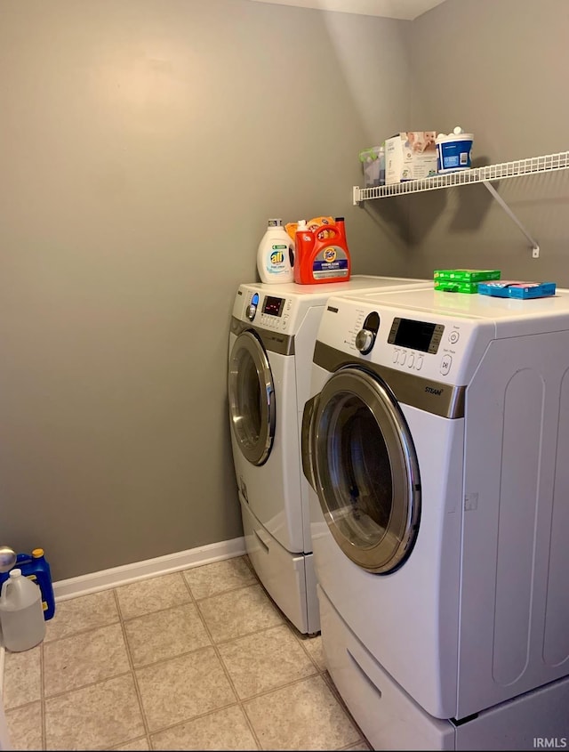 washroom with separate washer and dryer and light tile patterned floors