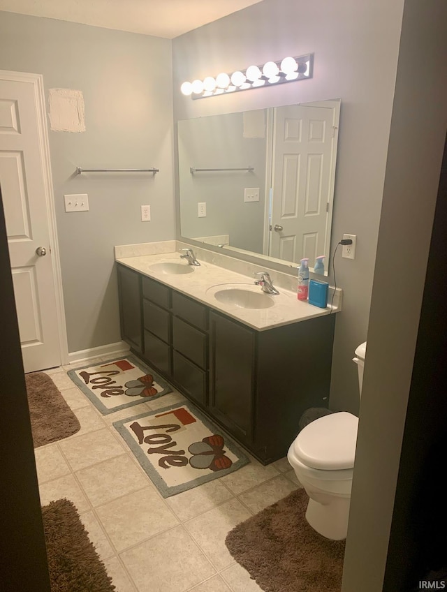 bathroom featuring vanity, tile patterned floors, and toilet