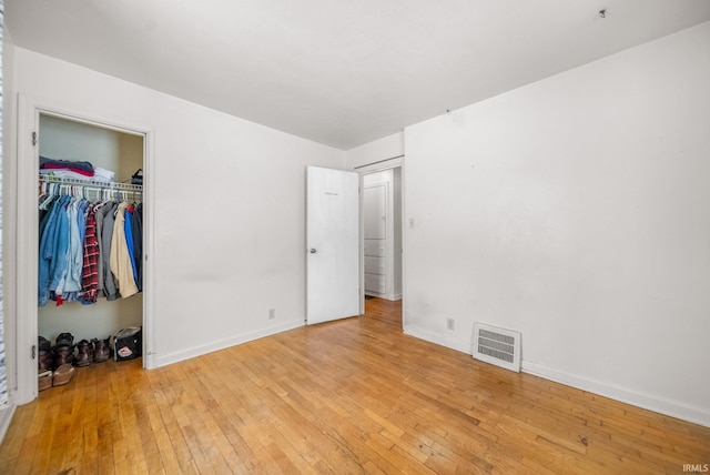 unfurnished bedroom featuring a closet and light wood-type flooring