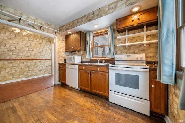 kitchen with dark hardwood / wood-style floors, sink, and white appliances