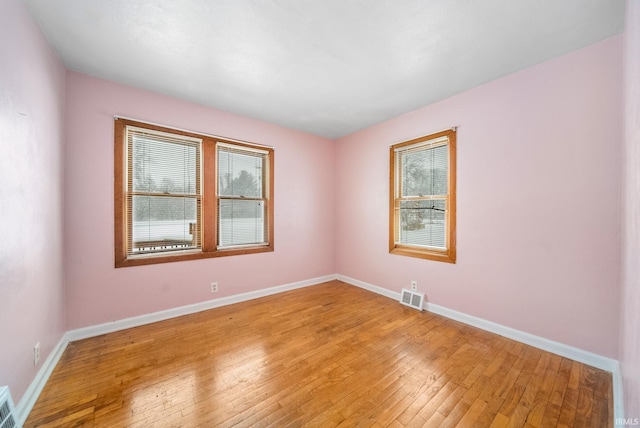 unfurnished room with light hardwood / wood-style floors