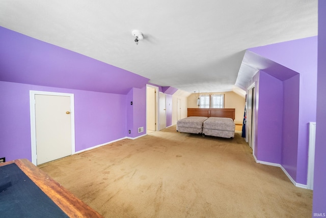 bonus room with lofted ceiling and light colored carpet