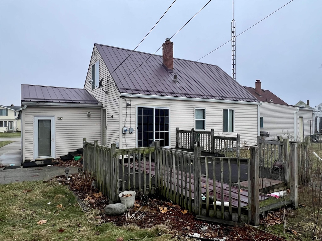 rear view of house featuring a wooden deck