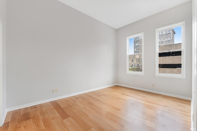 unfurnished room with light hardwood / wood-style flooring