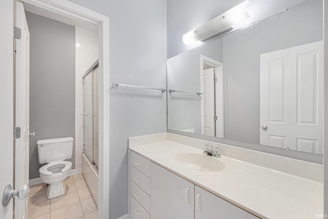 full bathroom with enclosed tub / shower combo, vanity, tile patterned floors, and toilet