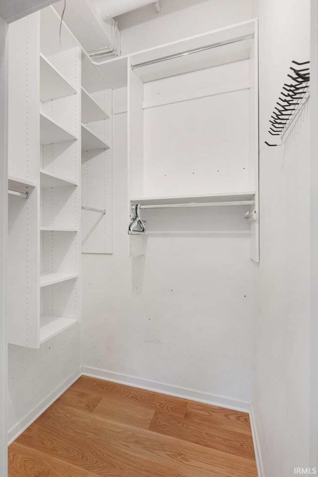 walk in closet featuring light hardwood / wood-style floors