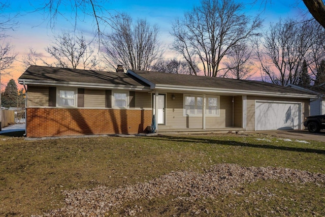 single story home with a yard and a garage