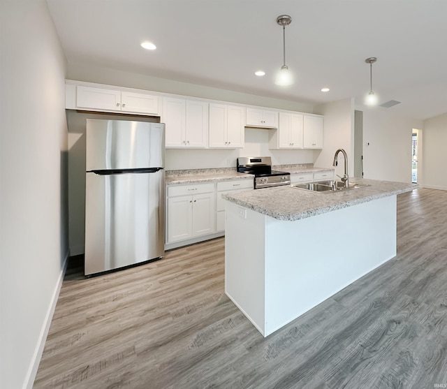 kitchen featuring stainless steel appliances, hanging light fixtures, sink, and white cabinets