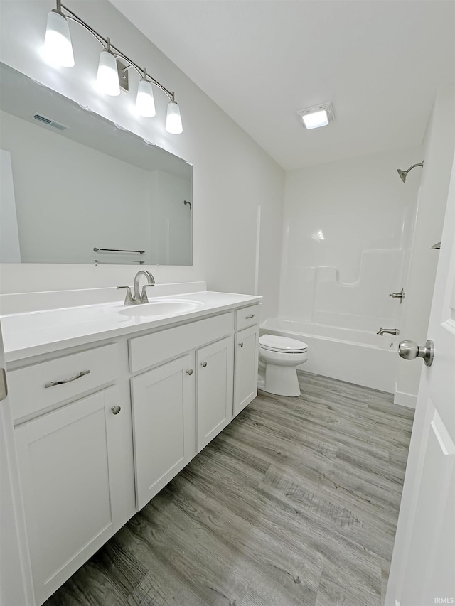 full bathroom featuring vanity, toilet, shower / bath combination, and hardwood / wood-style floors