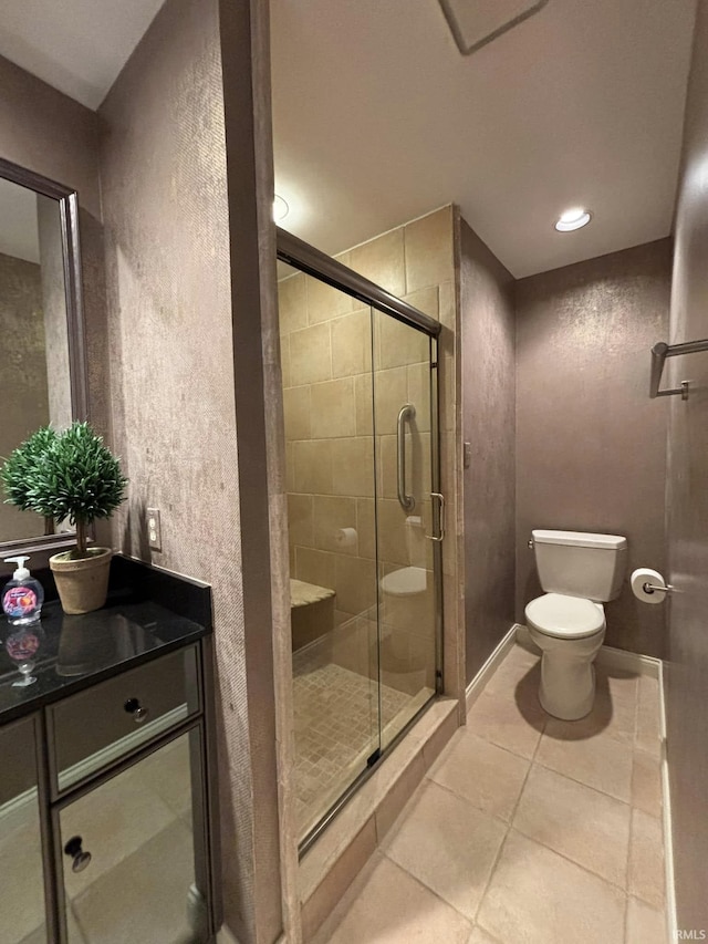 bathroom featuring walk in shower, tile patterned floors, and toilet