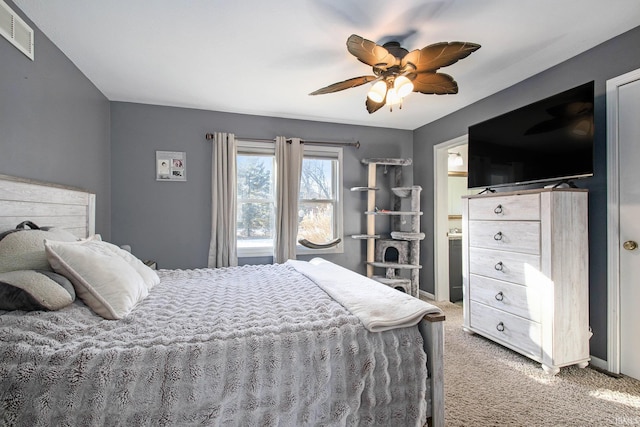 carpeted bedroom with connected bathroom and ceiling fan