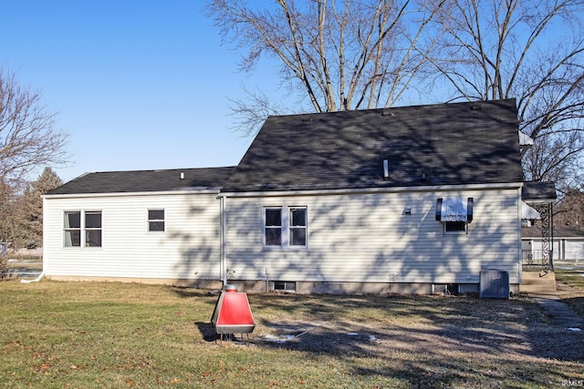 rear view of property with a yard