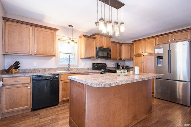 kitchen with dark hardwood / wood-style flooring, decorative light fixtures, a kitchen island, and black appliances