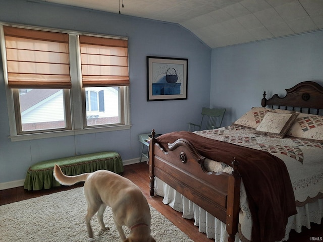 bedroom featuring lofted ceiling and wood-type flooring