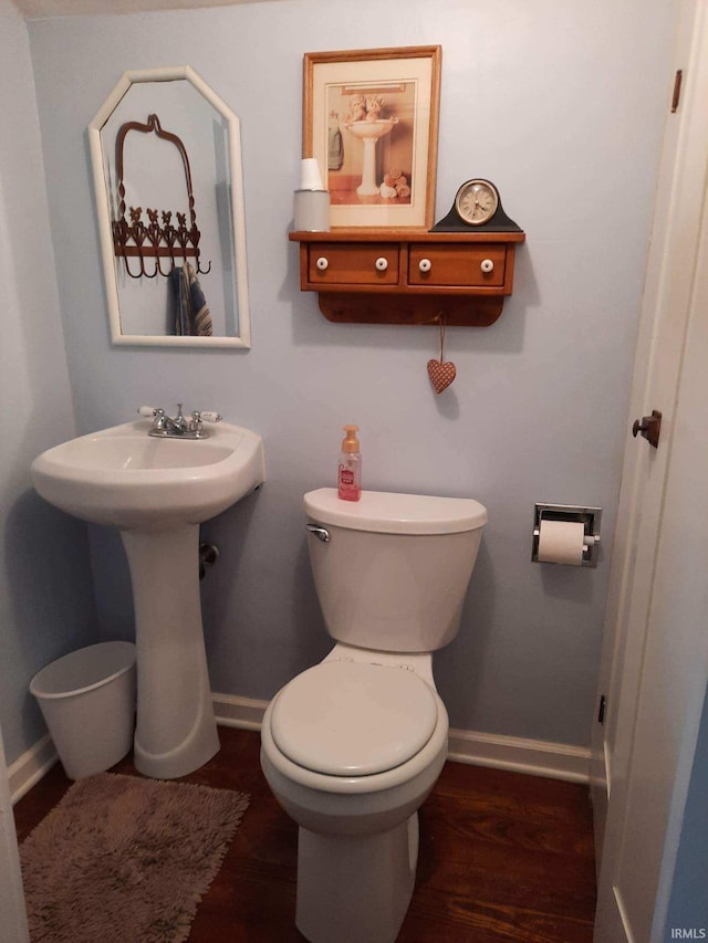 bathroom with hardwood / wood-style floors and toilet