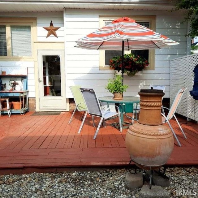 208 NE 10th St, Washington, IN 47501 - wooden terrace with outdoor dining area