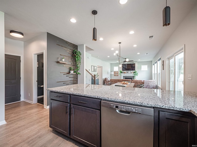 kitchen with dark brown cabinets, dishwasher, pendant lighting, light stone countertops, and light hardwood / wood-style floors