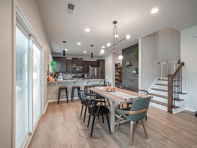 dining area with light hardwood / wood-style floors