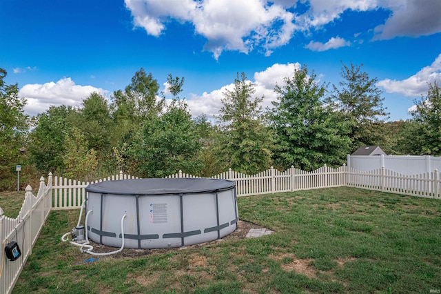 view of yard with a covered pool