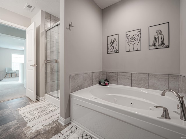 bathroom featuring shower with separate bathtub