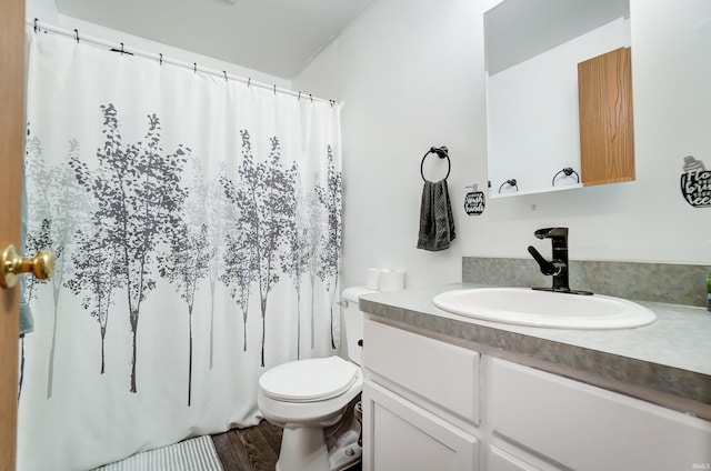 bathroom with vanity, hardwood / wood-style floors, and toilet