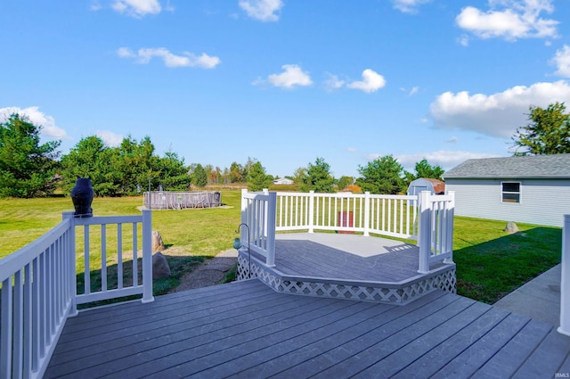 wooden terrace with a pool, a storage unit, and a lawn