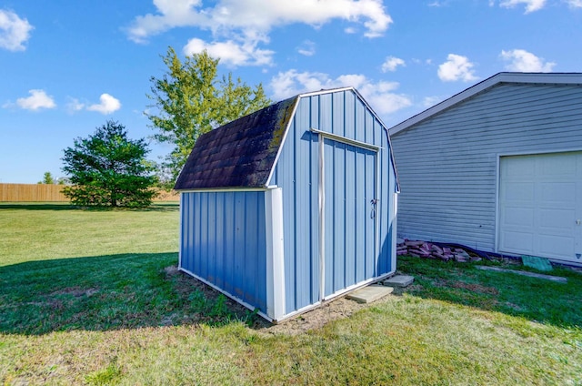 view of outbuilding with a yard