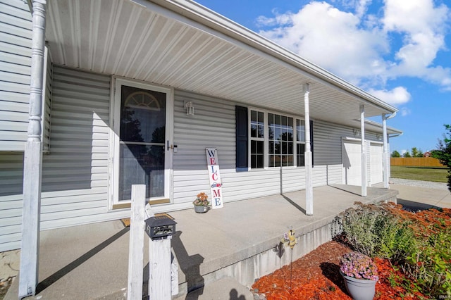 view of patio with a garage and a porch