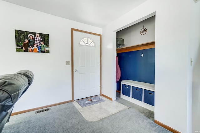 foyer entrance with carpet floors