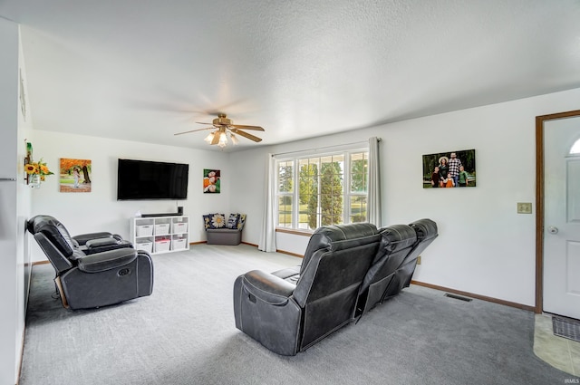 carpeted living room featuring a textured ceiling and ceiling fan