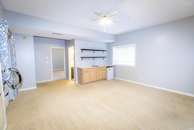 unfurnished living room with light carpet and ceiling fan