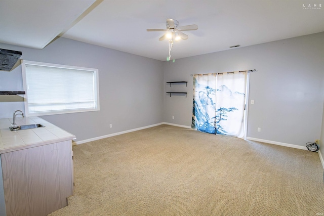 interior space with sink and ceiling fan