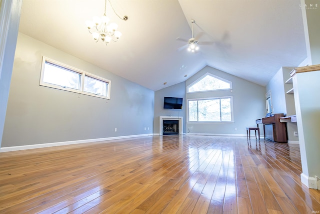 living room with lofted ceiling, ceiling fan with notable chandelier, and light hardwood / wood-style floors