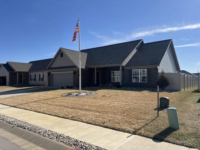 ranch-style home featuring a garage and a front lawn