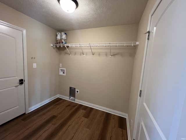 washroom featuring electric dryer hookup, dark wood-type flooring, washer hookup, and a textured ceiling