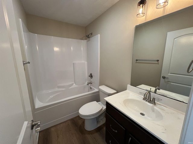 full bathroom with hardwood / wood-style flooring, vanity, bathtub / shower combination, and toilet