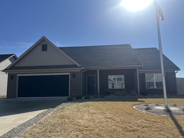 view of front of property featuring a garage and a front yard