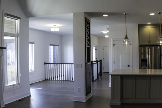 kitchen with gray cabinets, decorative light fixtures, dark hardwood / wood-style floors, and stainless steel fridge with ice dispenser