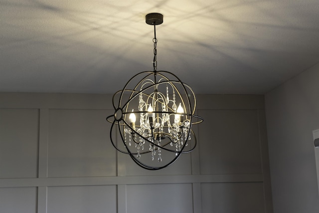 interior details featuring an inviting chandelier