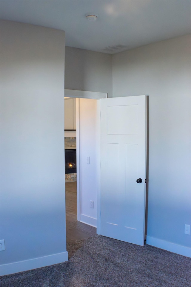 unfurnished bedroom featuring dark carpet