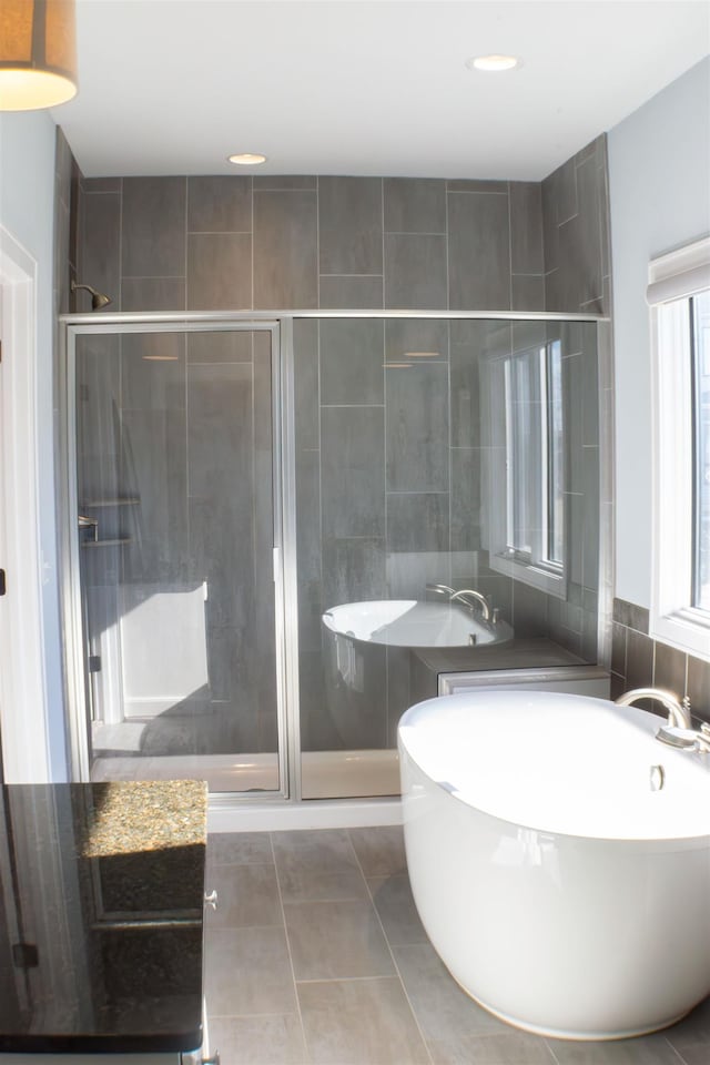 bathroom with tile patterned flooring and an enclosed shower